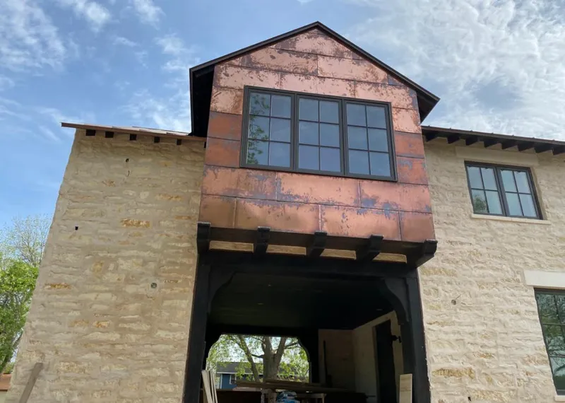 Copper metal panel facade on a stone building for Metal Roof Coating in Junction City