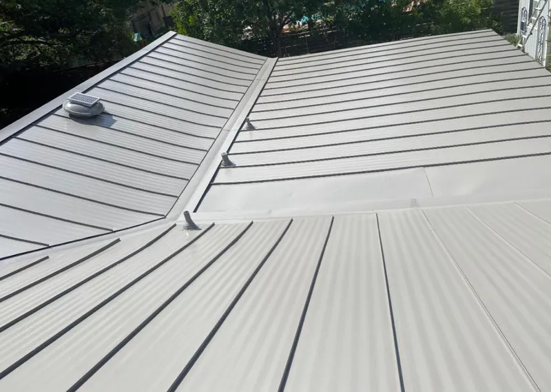 Solar attic fan installed on a metal roof for Roof Ventilation in Junction City